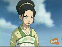 Toph, fair-skinned girl in a long-sleeved robe and band across her chest. Her eyes are pale green with faint pupils, signifying blindness