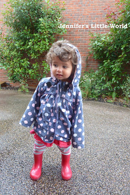 Small child in wellies in the rain