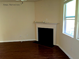 a corner gas fireplace with black tile surround