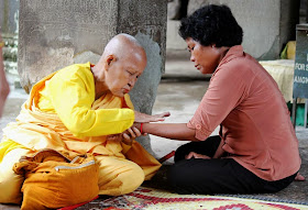 Holy man tying sacred thread