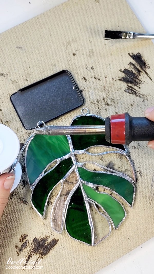 Find something, like a tin lid, to rest the wire loops on while soldering them to the monstera leaf.   Have your pliers on hand in case you need to adjust, but don't use your fingers...that little loop will be hot!