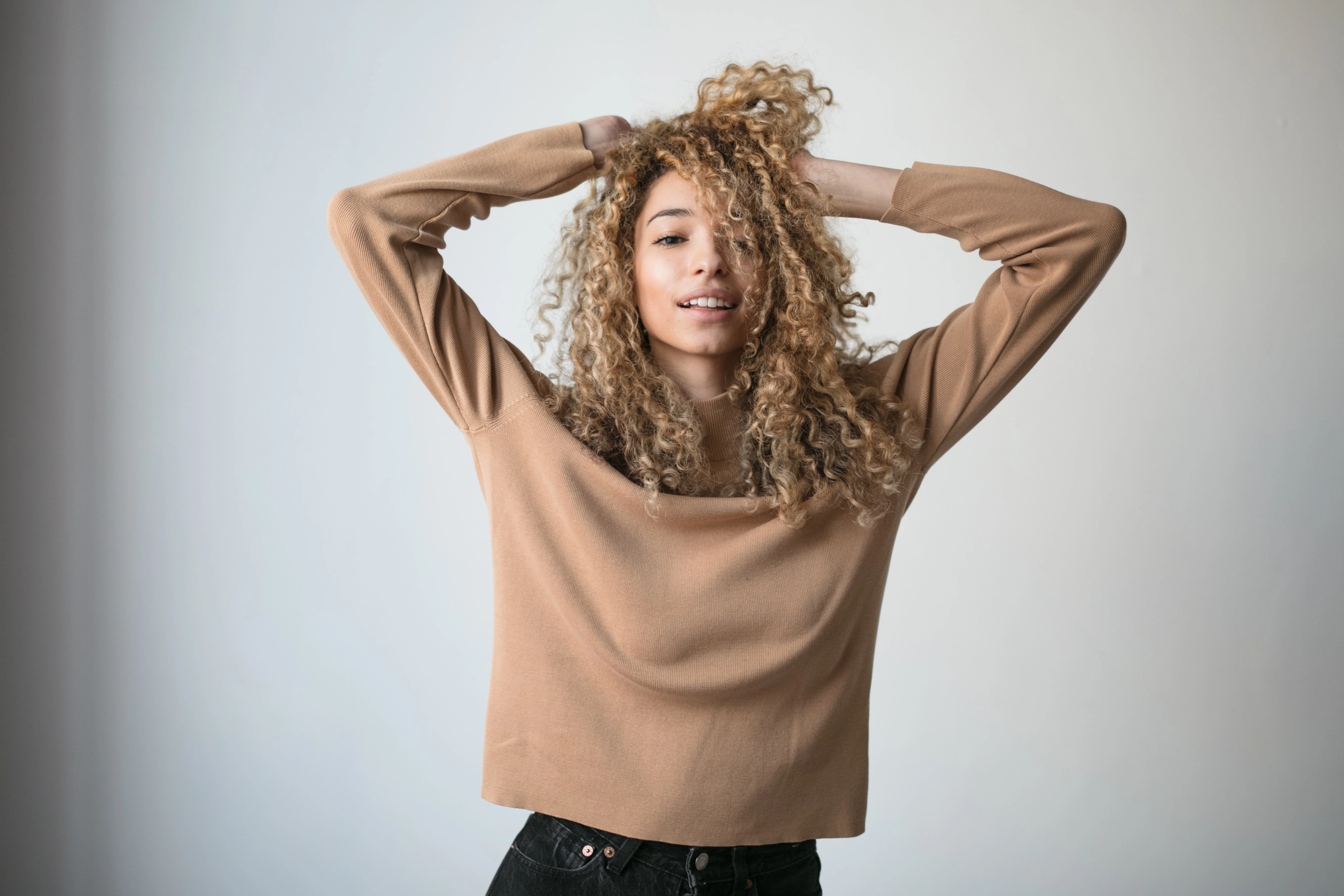 women with beautiful curly hair looking confident and happy