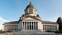 The Washington Capitol Building in Olymia with a blue sky in the background