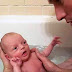 Dad showers with his baby girl for the first time and is in awe of her every move