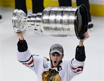 Chicago Blackhawks' Jonathan Toews hoists the Stanley Cup after defeating the Boston Bruins