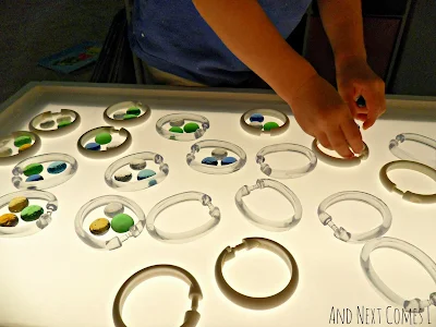 Grouping on the light table using shower curtain rings and glass stones from And Next Comes L