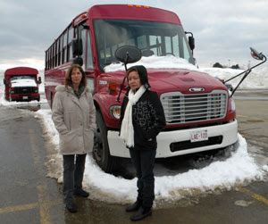 Isabelle Hains and Ana Acevedo in front of the new multifunctional buses at Bathurst High School, March 7, 2009