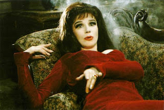 Still from Carry on Screaming of Fenella Fielding character lying on chair. 