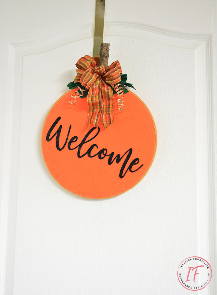 A simple easy peasy embroidery hoop pumpkin wreath tutorial for budget fall decorating with thrift finds, fabric scraps and ribbon you have on hand.