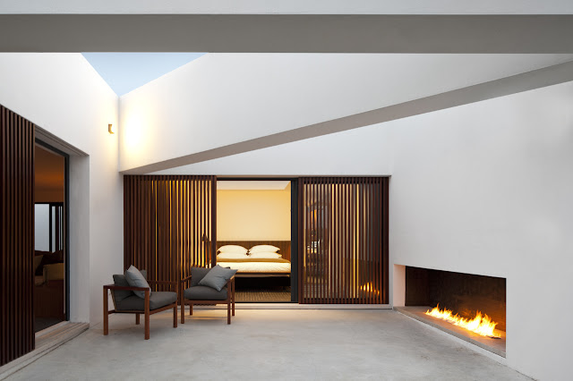 Picture of modern bedroom as seen from the terrace with outdoor fireplace 