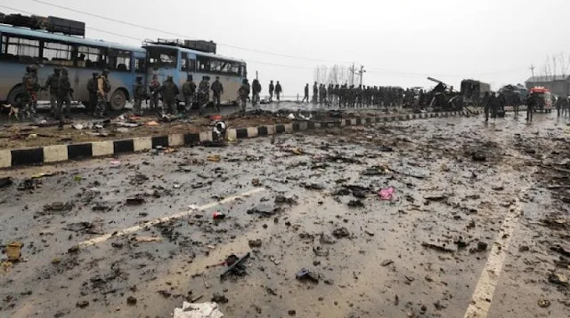 Image Attribute: Indian security forces inspect the remains of a vehicle following a bomb attack in Pulwama on February 14, 2019. / Source: Twitter