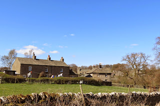 Stone cottages on the edge of the village, with washing drying on the line outside.