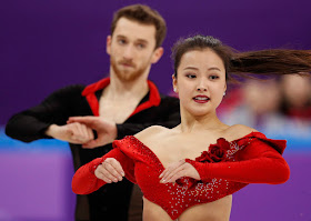 South Korean Min Yura battled on after a hook popped on her dress just seconds into her routine