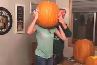 Teenage girl gets her head stuck in massive pumpkin
