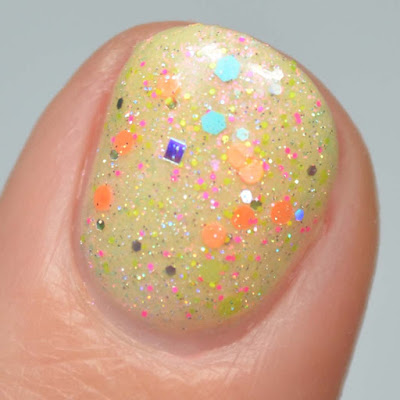 neon glitter nail polish topper swatched over yellow