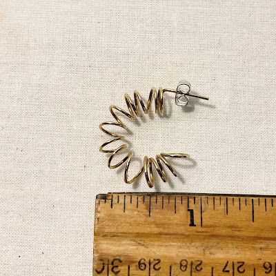 Coiled wire earrings with ruler for size
