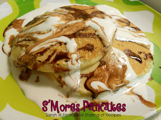 S'mores Pancakes | Homemade graham cracker pancakes topped with a homemade chocolate syrup and a little storebought marshmallow creme = heaven in your mouth! #breakfast #smores #chocolate #marshmallow #pancakes