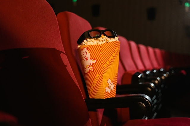 popcorn and glasses on chair in theatre