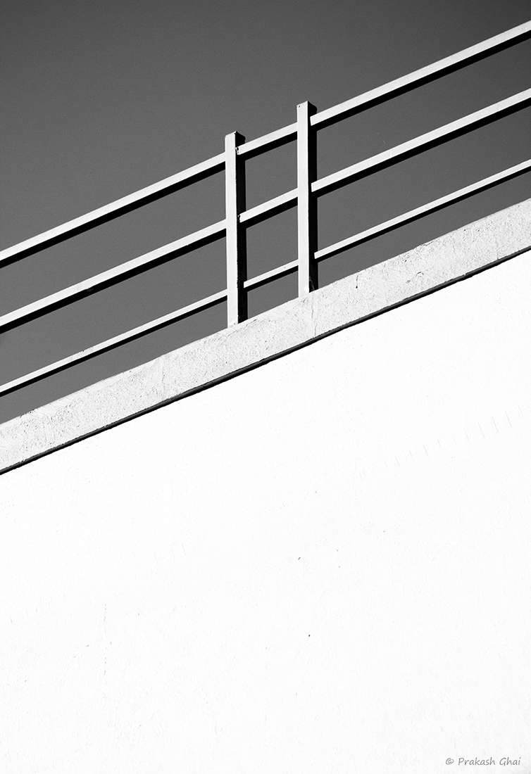 A black and white Minimalist Photo composed using a terrace railing.