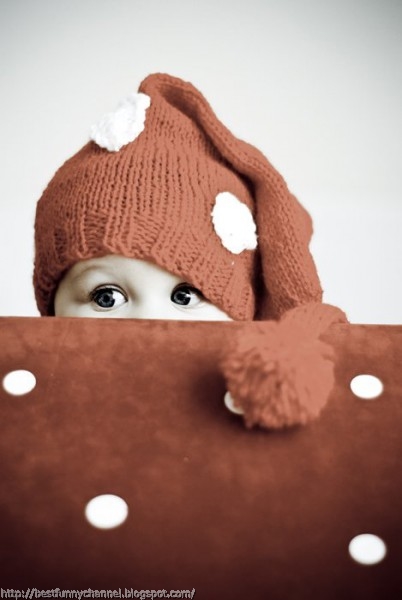 Baby in red cap.