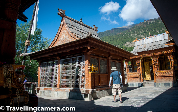 If you pay attention to above photograph, you may realise that this temple is surrounded from all four sides with different structures and it's pretty tight. The shadows of surrounding structures is telling the story of space around Narayan Nagin Temple of Kalpa. One of friends paying attention to details like this yellow coloured tiger and wooden carvings on almost all the walls of the temple.