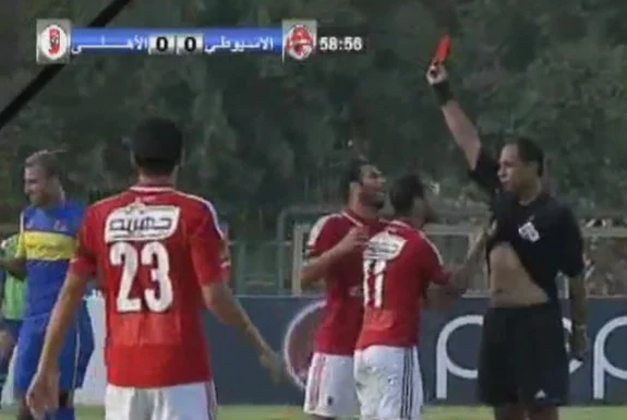 Al Ahly player Walid Soliman is seen lifting up referee's shirt after getting a red card
