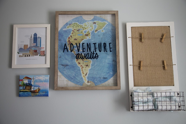 A travel and adventure-inspired gender neutral nursery with pops of pale gray, white, blue, and pale green.
