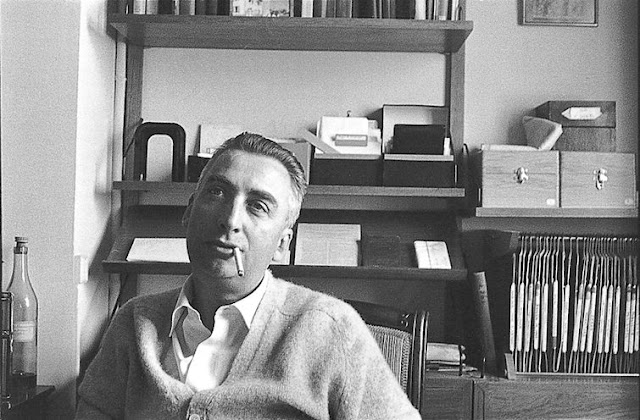 Roland Barthes sitting in his study.