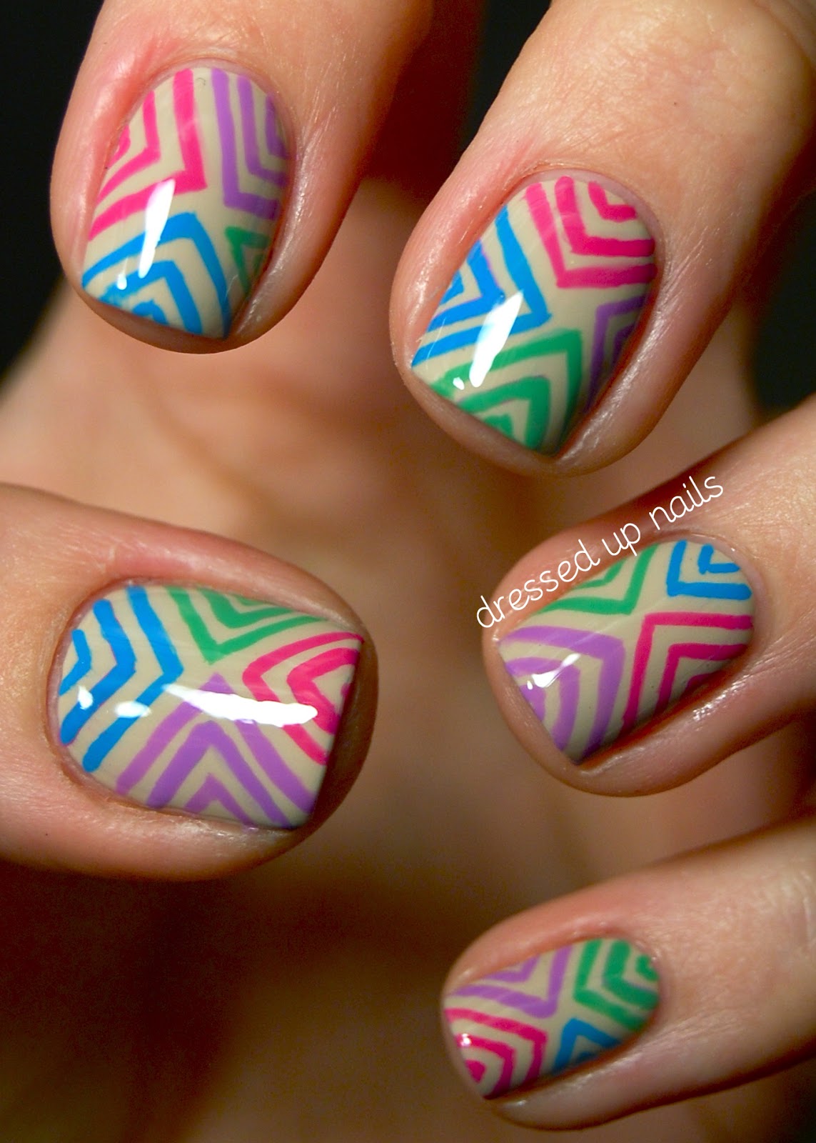 Dressed Up Nails: Colorful offset chevron nail art on a nude base 