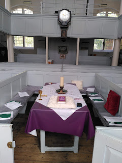 the large old table in the largest box pew at the centre of Ringwood Meeting House, known as the Elders' Pew, prepared ready for our gathering