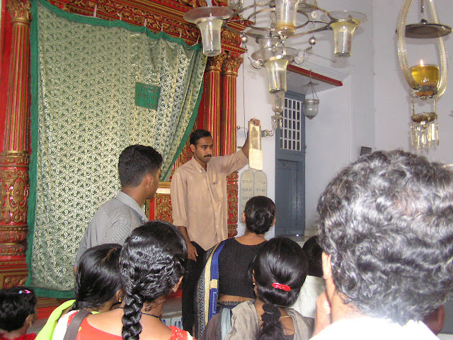 Display of old documents inside the Jewish syngague in Cochin by a tour guide