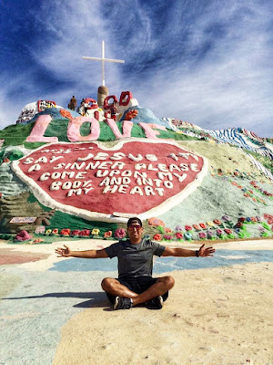 Sitting in front of Salvation Mountain 