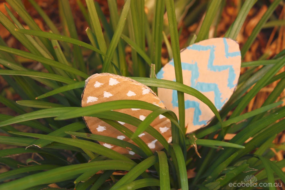 cardboard easter eggs hiding in the grass for a chocolate free easter hunt game