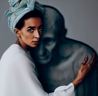 woman wearing a headwrap hugging her grandfother's ghost figure