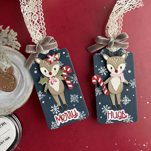 Christmas interactive gift tags made with: Spellbinders tinsel time sentiments, dancin' deer, opal gems, cardstock, winter blooms, decorative tag die; Scrapbook.com white pigment ink, snowflake stamps, smooth cardstock; Tim Holtz velvet trim