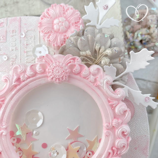 Mixed media shaker canvas created with: Sizzix circle panes, circle frames, creamy matte acrylic in cherry blossom, woodland stems, dimensional paste, pearlescent medium, sequin mix in ballet slipper; Prima lavender frost paper flowers, Finnabair mirror frame moulds, theater night stencil; Pinkfresh Studio glitter drops in blush; Reneabouquets butterflies