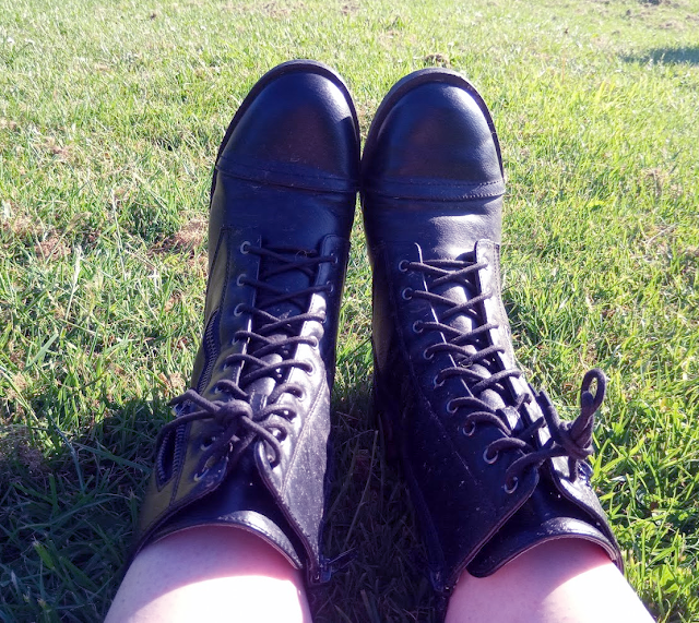 Army style boots on a sunny day, in a park