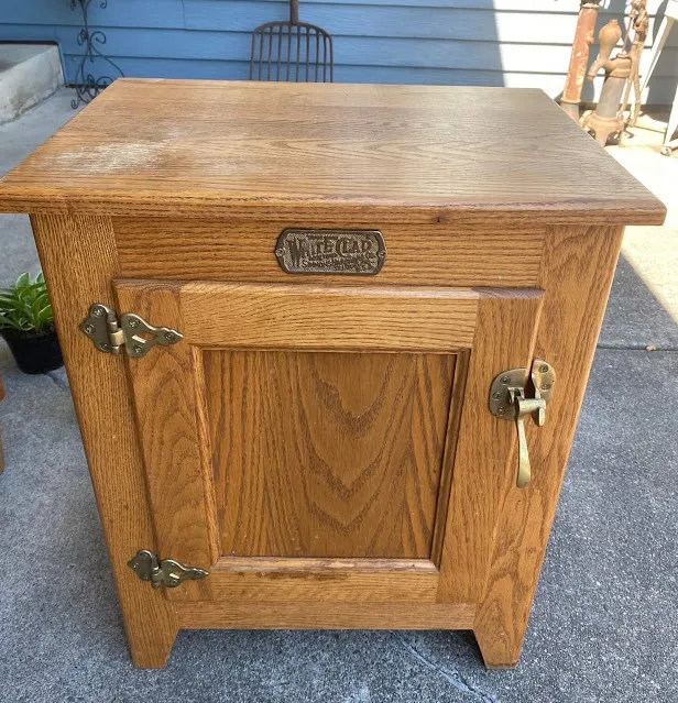 Photo of an oak, ice box style end table from a garage sale.