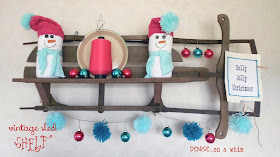 A vintage sled turned shelf decked out in teal and pink for Christmas via http://deniseonawhim.blogspot.com