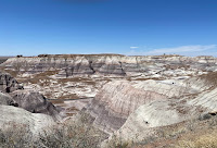 A landscape of hills and valleys featuring colorful striations.