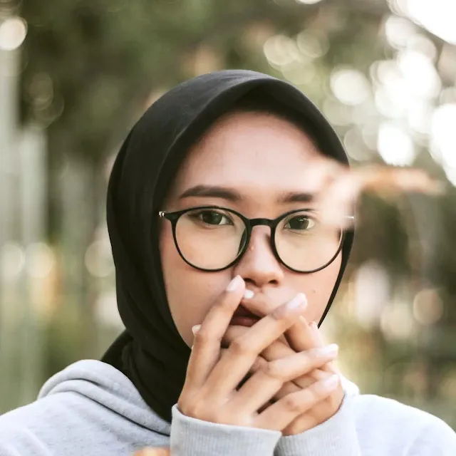 Young woman in a black hijab looking perplexed
