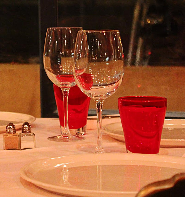 two wine glasses on a set table