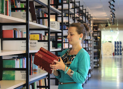 image: https://pixabay.com/photos/young-woman-books-shelves-library-995187/