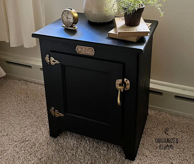 Photo of an oak, ice box style end table upcycled and repurposed as a bedroom nightstand.