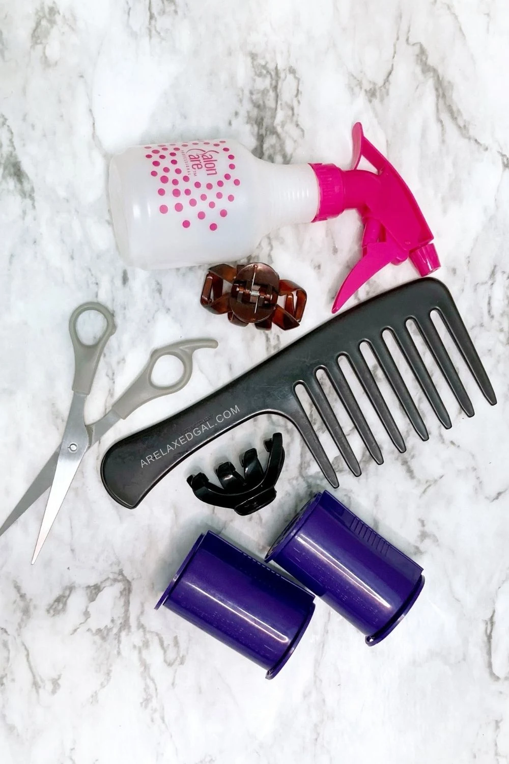 hair tools for relaxed hair lying on a pretty granite countertop.