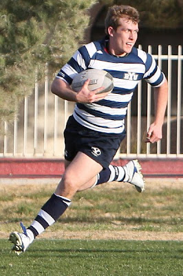 BYU Rugby Flyhalf Dylan Lubbe swings past the defense with fire in his eyes
