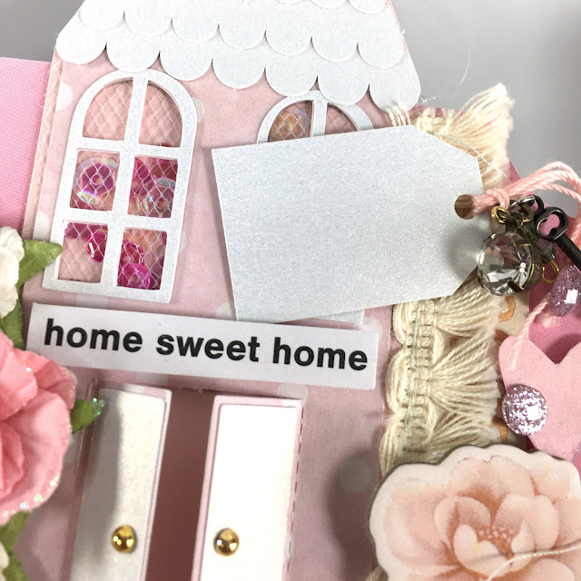 Heidi Swapp Memorydex Valentine's advent calendar made with the Prima With Love collection by Frank Garcia; miniature mini house shaker die cut with tag decorated with ephemera, stickers, paper flowers, tassel trim, tulle, sequins and charms