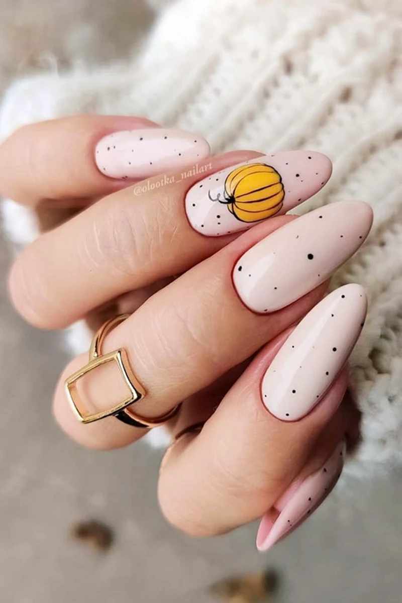 close-up of woman hand with a very cute and minimal halloween nail design