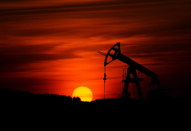 an oil rig during sunset.