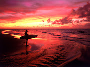 Hawaii surfing has long been part of Polynesian culture. (surfer at twilight hawaii)